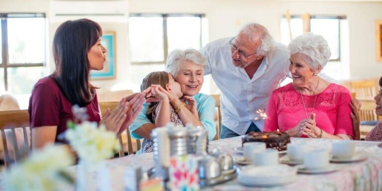 Elderly Group Sharing Meals And Laughing Together At an Independent Living Facility