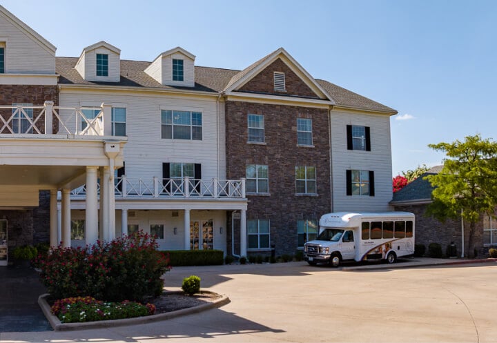 Building Exterior with Resident Shuttle Bus at Assisted Living Facility Building Exterior with Resident Shuttle Bus at Assisted Living Facility