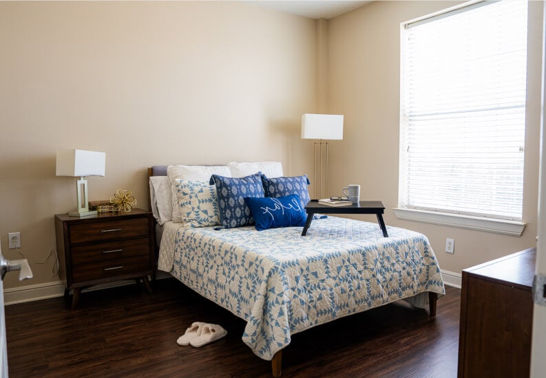 Cozy Resident Bedroom with Wood Flooring at Memory Care Facility