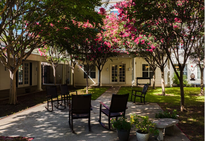 Outdoor Courtyard with Rocking Chairs at Assisted Living Facility Outdoor Courtyard with Rocking Chairs at Assisted Living Facility