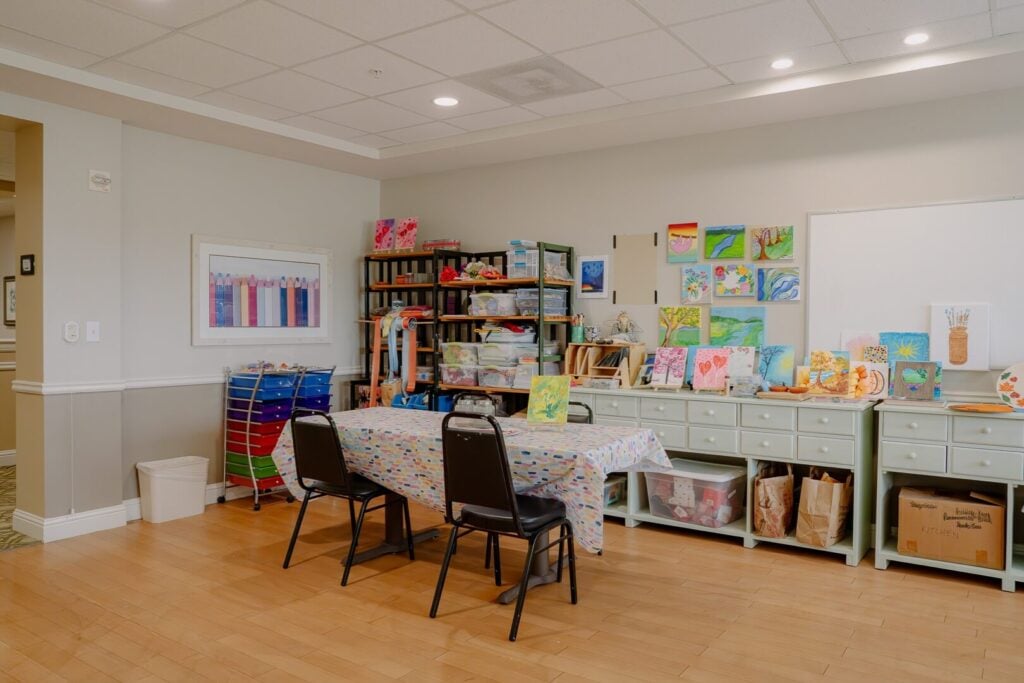 Bright Art Studio with Resident Paintings at Assisted Living Facility