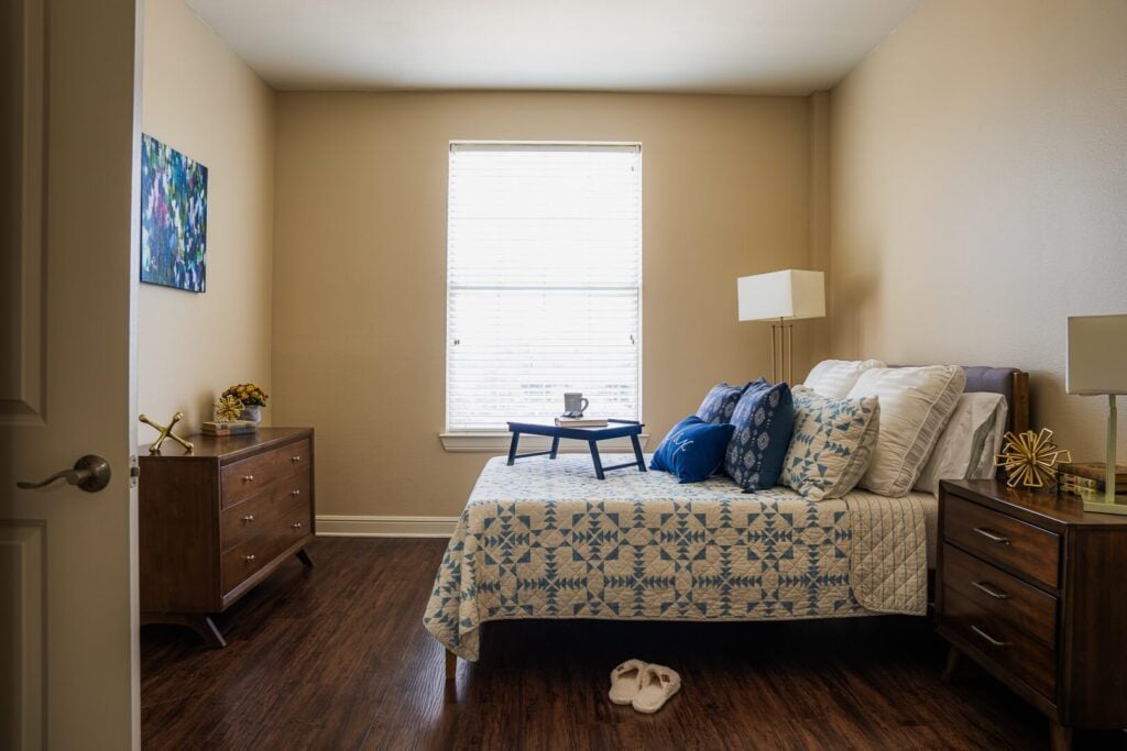 Comfortable Resident Bedroom with Wood Furnishings at Memory Care Facility