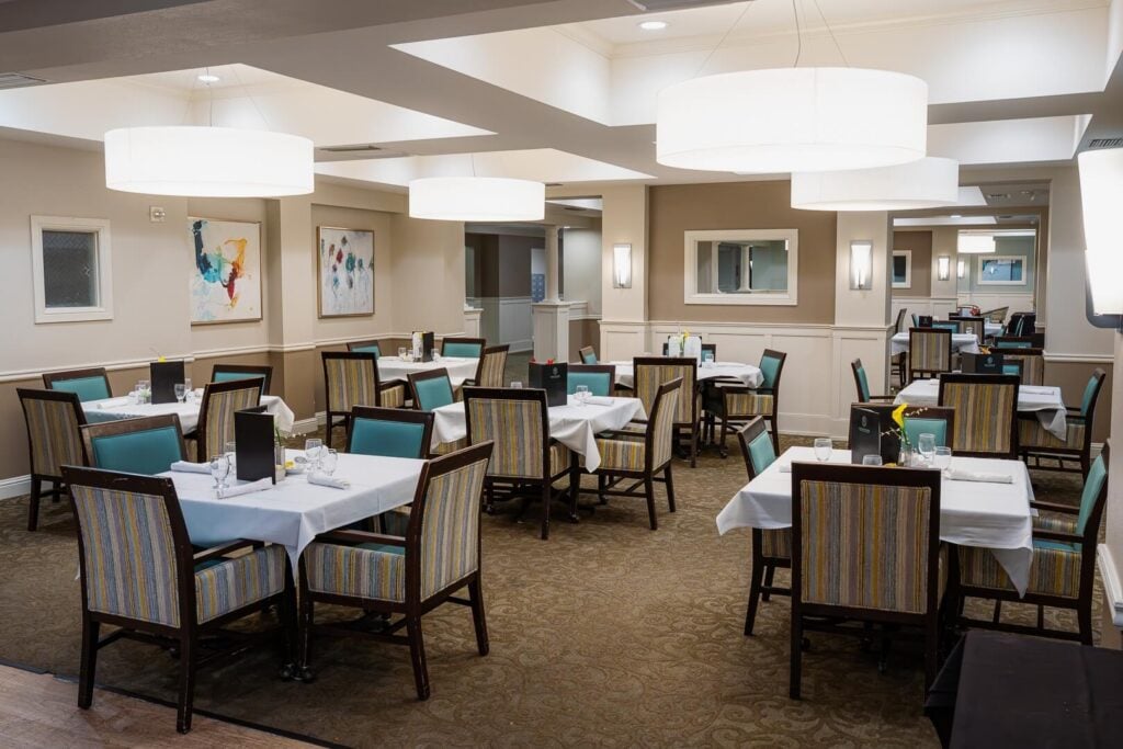 Bright Dining Room with Set Tables at Memory Care Facility