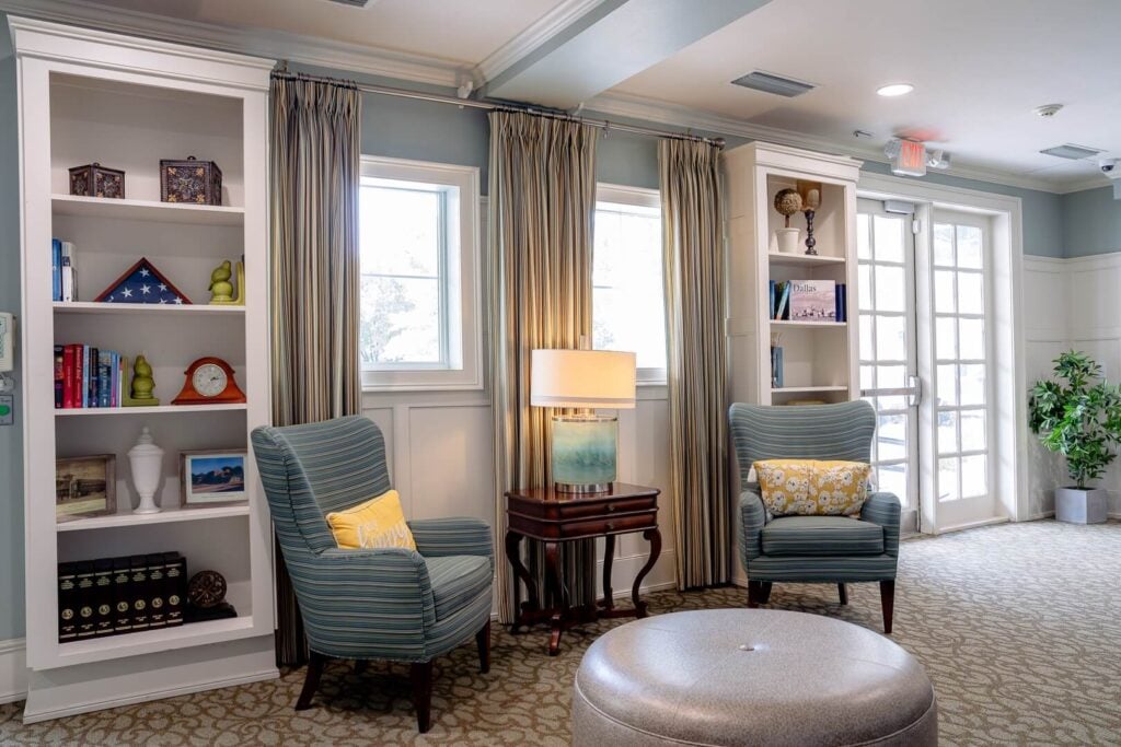 Cozy Sitting Area with Bookshelves at Assisted Living Facility