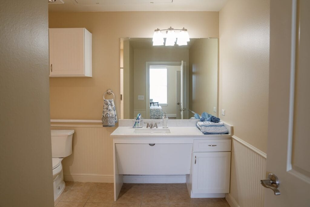 Accessible Bathroom with Vanity and Mirror at Assisted Living Facility